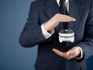 businessman holding car icon